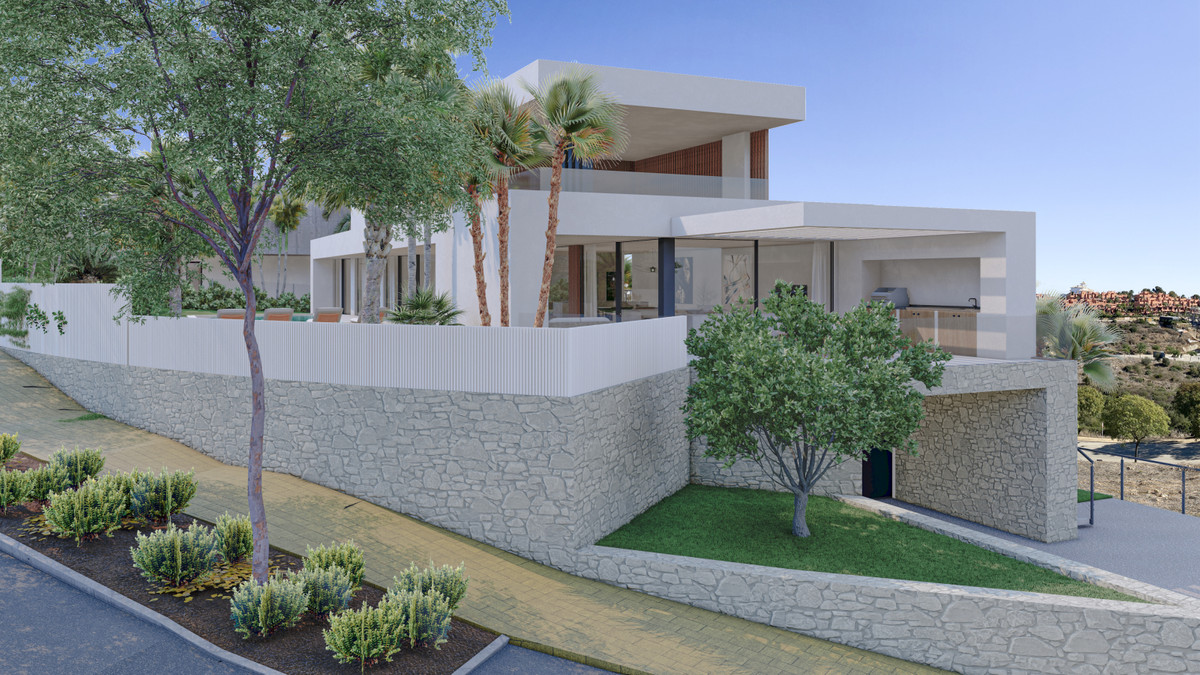Villa Natalie – Manilva - modern luxury villa exterior with stone retaining walls, landscaped garden, palm trees and covered terrace