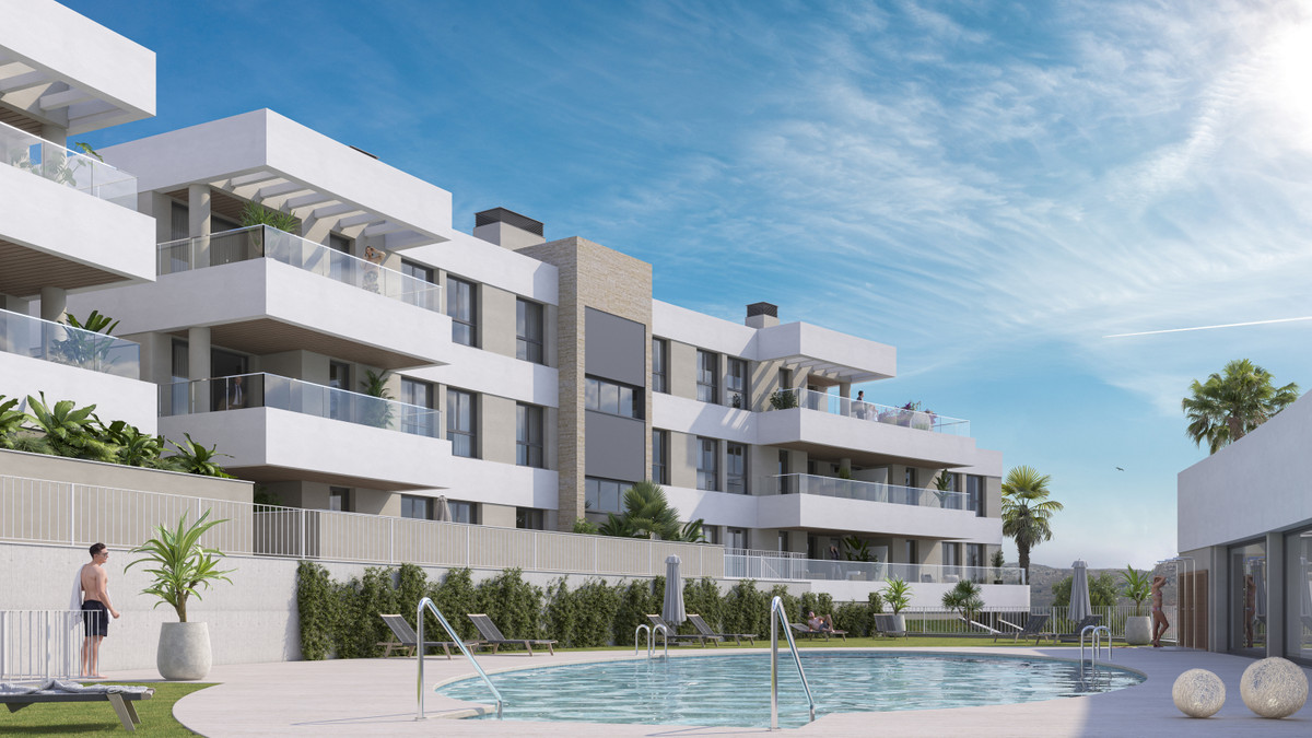 Insur Scala – Estepona - modern apartment complex exterior with communal pool, landscaped gardens, and private balconies under a blue sky