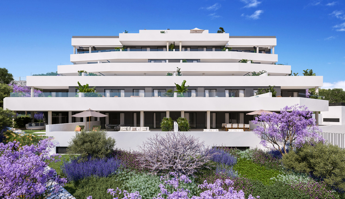 Medblue IV – Altos de los Monteros - modern white terraced facade surrounded by purple jacaranda trees and lush Mediterranean gardens