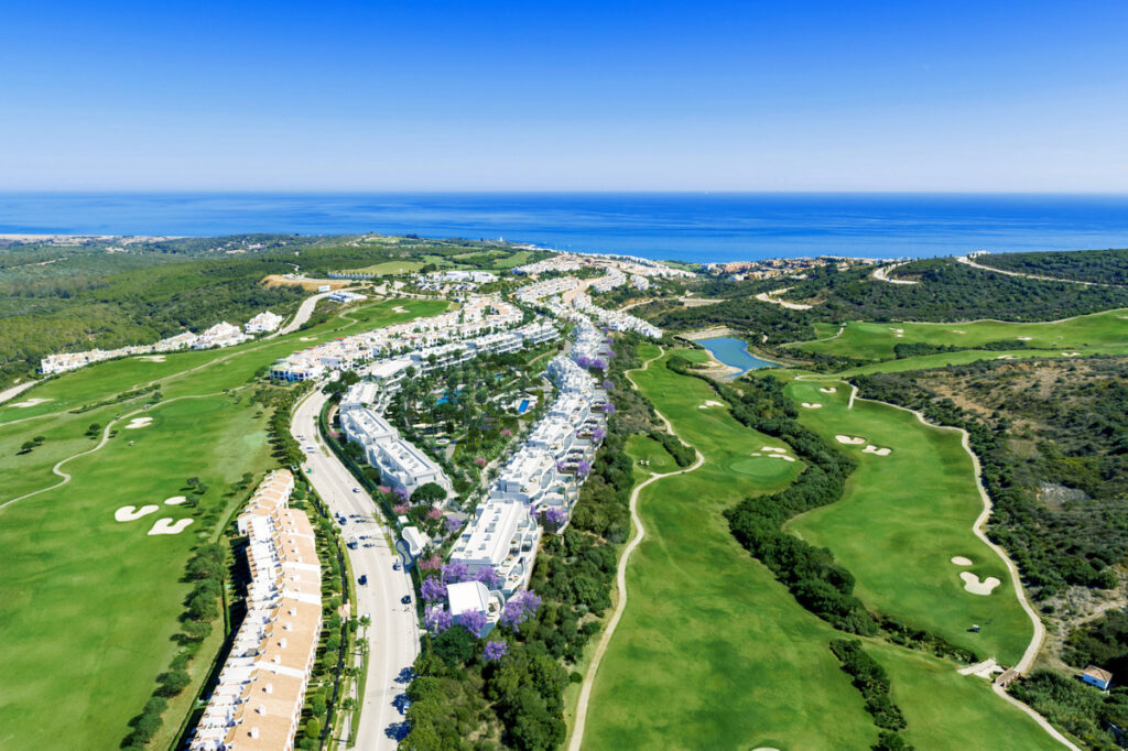 Serenity Frontline Golf Homes and Beach Club – PHASE III – La Alcaidesa - aerial view of luxury new-build development beside golf course with Mediterranean Sea in background