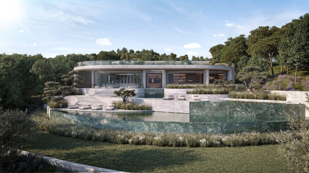 VILLA DUNE – The Fifteen – Sotogrande - curved luxury villa exterior with marble-edged infinity pool, terraced gardens and woodland backdrop