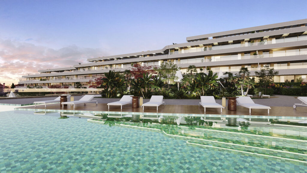 Arosa - Mijas luxury residential complex featuring an infinity pool, sun loungers, and lush tropical gardens at dusk