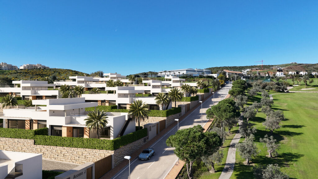 GREEN VALLEY FASE II – Mijas - aerial view of white modern villas with palm trees beside a green golf course under blue skies