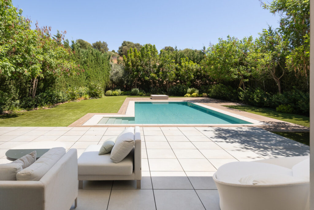 Nine in Paradise – Estepona - luxury outdoor pool terrace with white lounge seating and landscaped garden